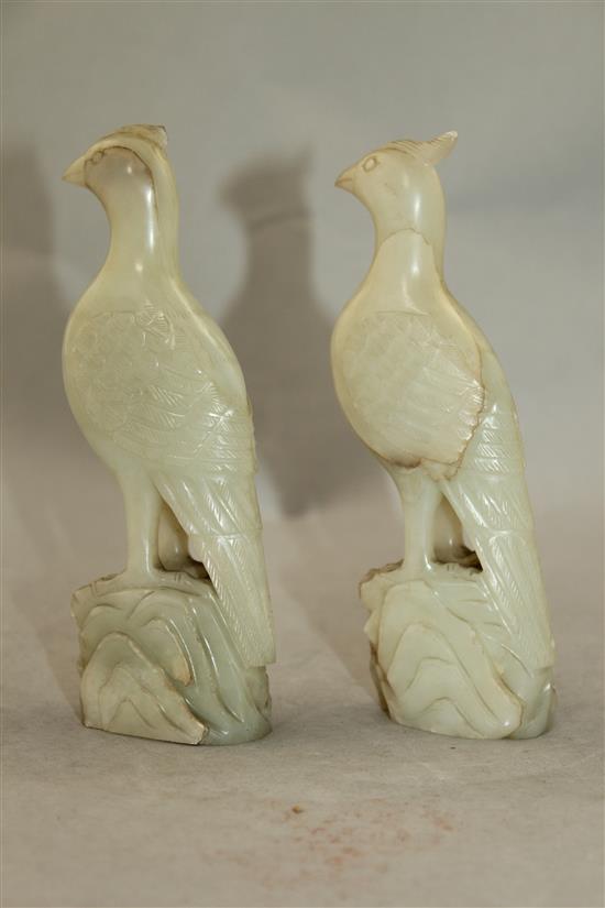 A pair of celadon-white jade standing figures of pheasants, 20th century, 4.3cm, chips to crests